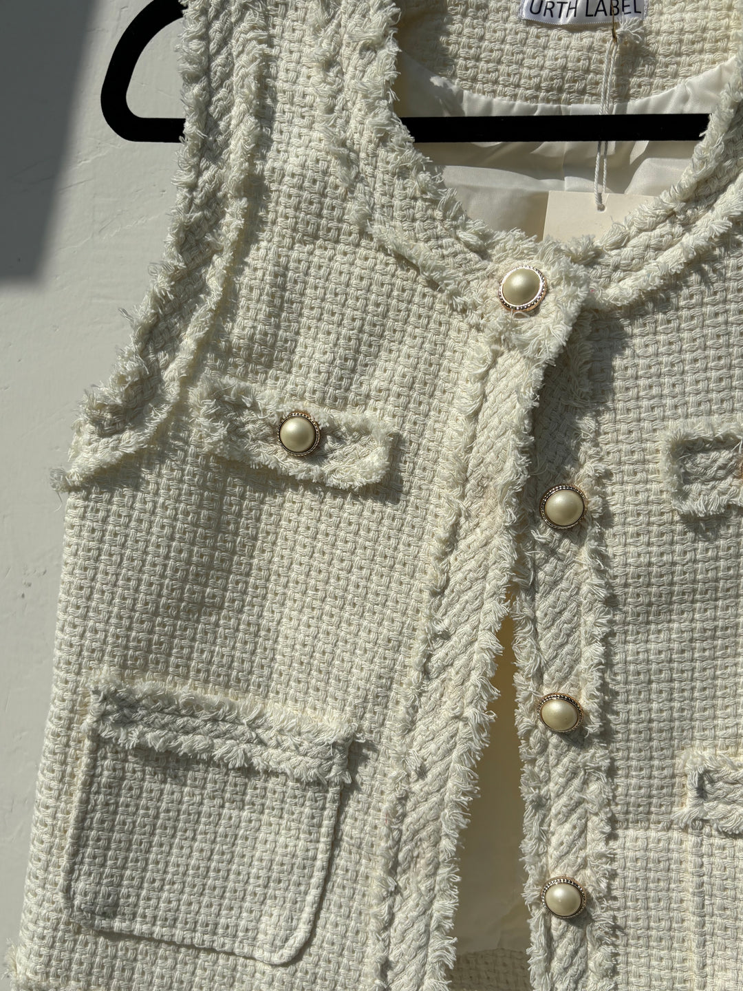 White sleeveless tweed jacket